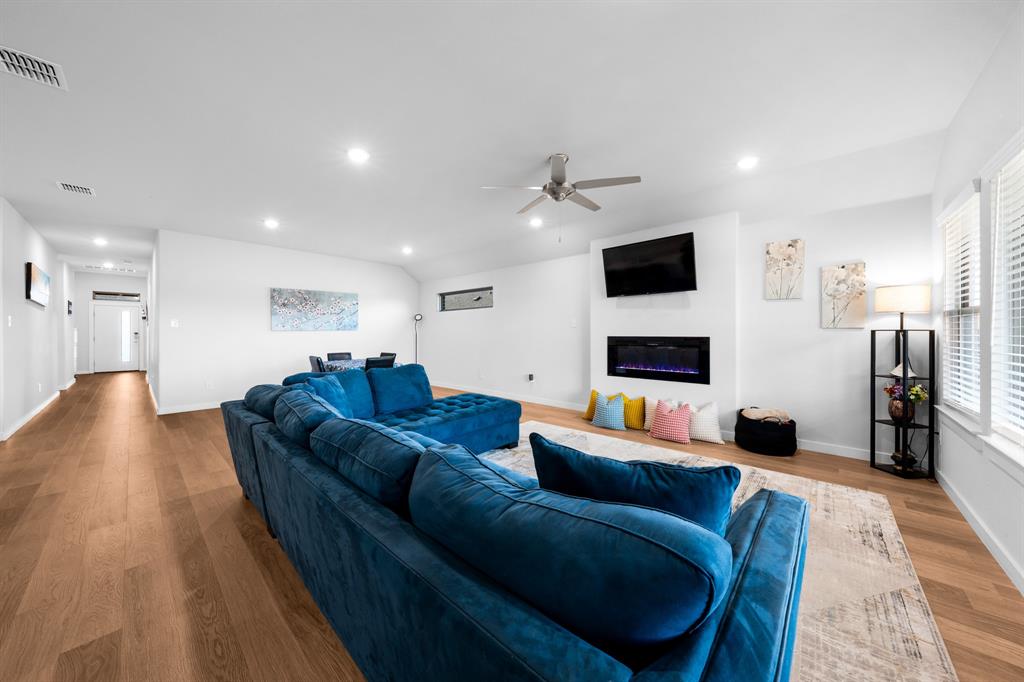 1012 Breezy Street Princeton, TX 75407 - Photo 9 of 34 a living room with furniture and a flat screen tv