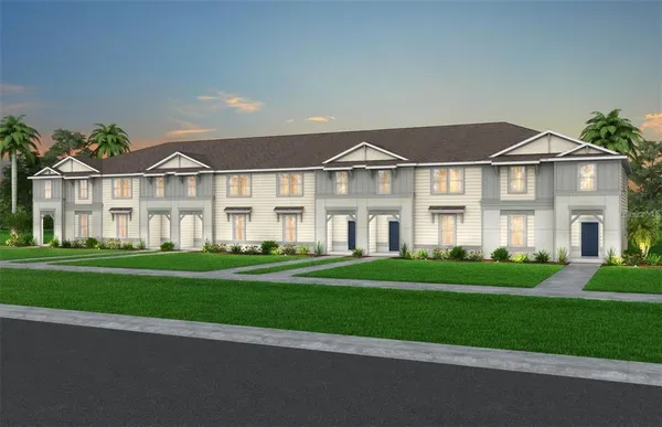 a front view of a house with a yard and trees