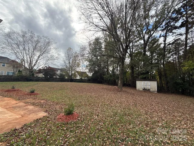 a view of yard with wooden fence