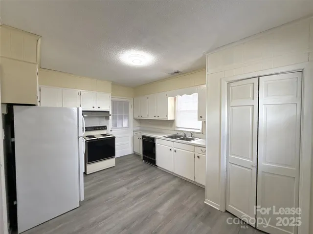 a kitchen with stainless steel appliances a refrigerator sink and stove