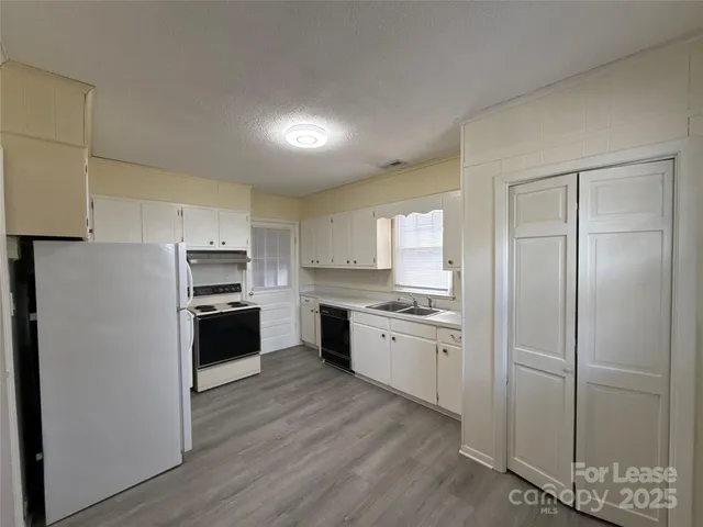 a kitchen with a refrigerator stove and sink