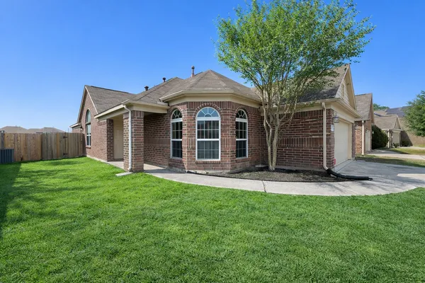 a front view of a house with a garden and yard