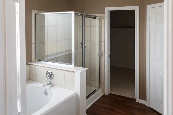 a bathroom with a tub and shower