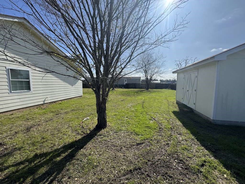 3 John Kay Road Huntsville, TX 77320 - Photo 18 of 22 a view of a backyard with large trees
