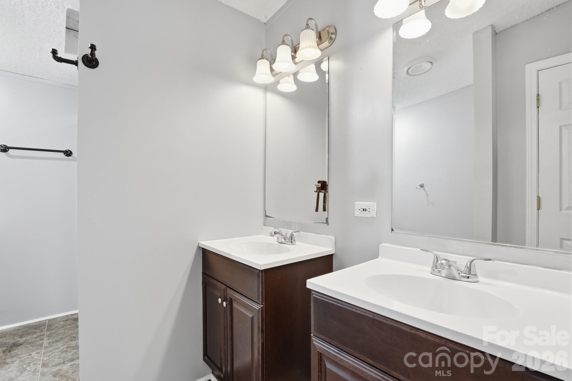 605 Ridgewood Court Mount Holly, NC 28120 - Photo 12 of 32 a bathroom with a sink and a mirror