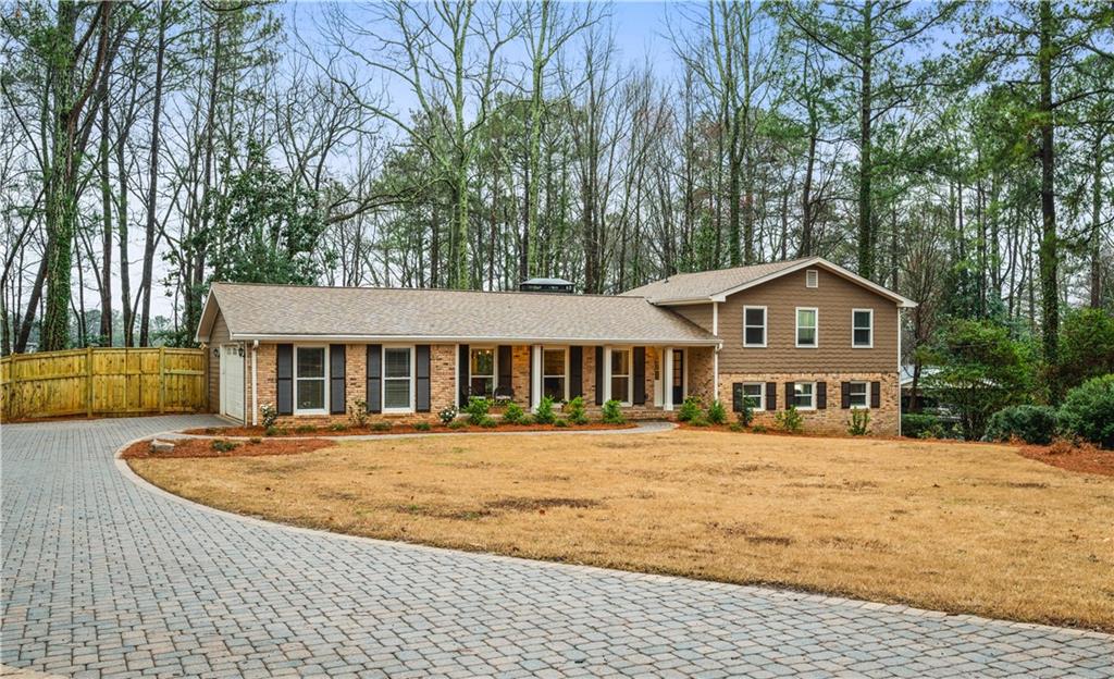 591 Dalrymple Road Atlanta, GA 30328 - Photo 1 of 1 a front view of a house with a yard