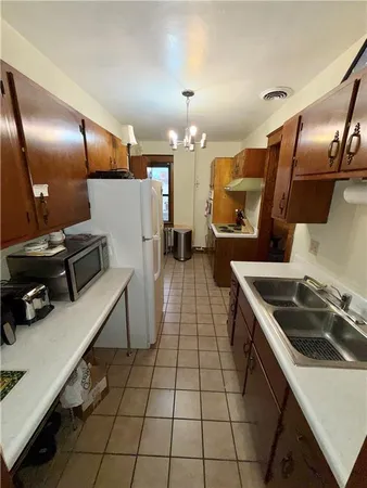 a kitchen with a sink stainless steel appliances and cabinets