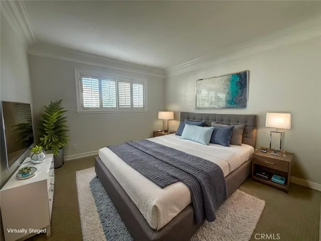 a bedroom with a bed and a potted plant