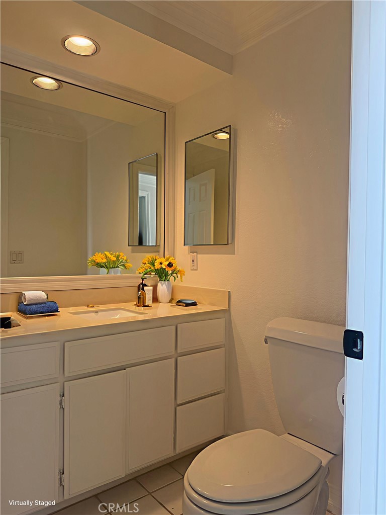 33665 Via Lagos Dana Point, CA 92629 - Photo 14 of 23 a bathroom with a toilet a sink a mirror and vanity