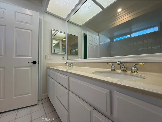 a bathroom with a double vanity sink and a mirror