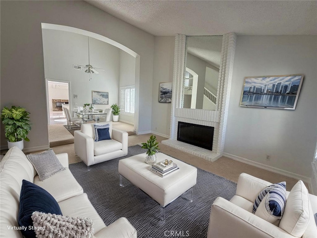 33665 Via Lagos Dana Point, CA 92629 - Photo 3 of 23 a living room with furniture and a fireplace