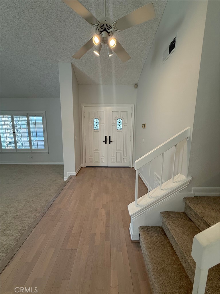 33665 Via Lagos Dana Point, CA 92629 - Photo 4 of 23 a view of a livingroom with wooden floor and a ceiling fan