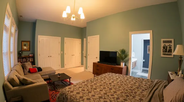 a bedroom with a bed and a flat screen tv