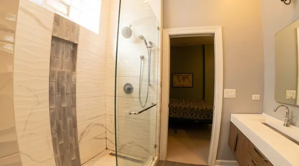 a en suite bathroom with a shower and a sink