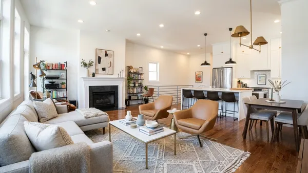 a living room with furniture fireplace and dining table