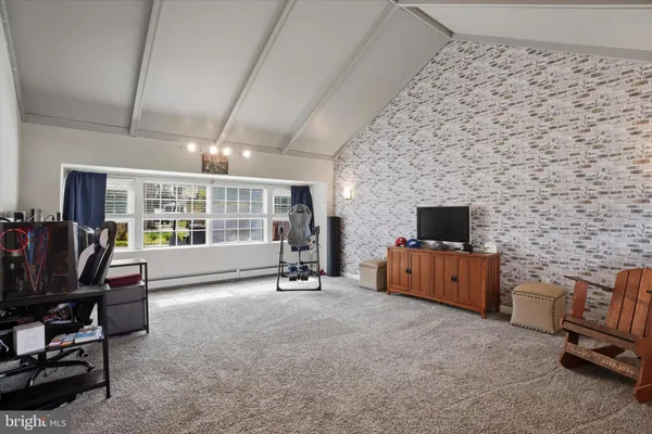 a view of a livingroom with workspace and a window