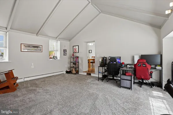 a view of a room with furniture and a fan