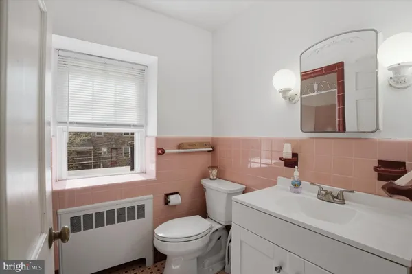 a bathroom with a sink toilet and mirror