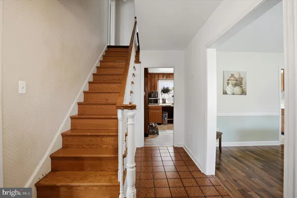 a view of entryway and hall with wooden floor