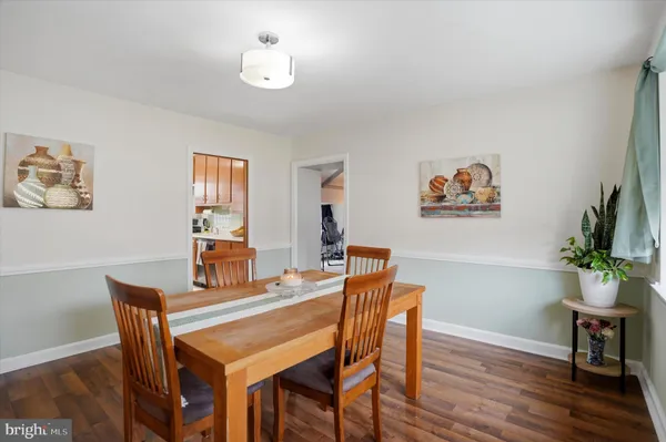a dining room with furniture and wooden floor