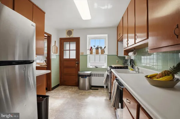 a kitchen with a refrigerator and a stove