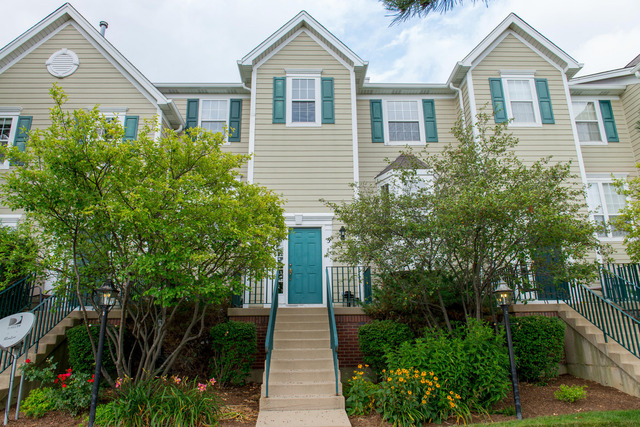 2422 Courtyard Circle, Unit 3 Aurora, IL 60506 - Photo 1 of 25 a front view of a house with a yard and trees