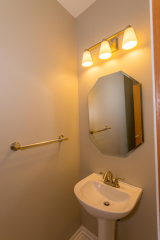 2422 Courtyard Circle, Unit 3 Aurora, IL 60506 - Photo 12 of 25 a bathroom with a sink and mirror