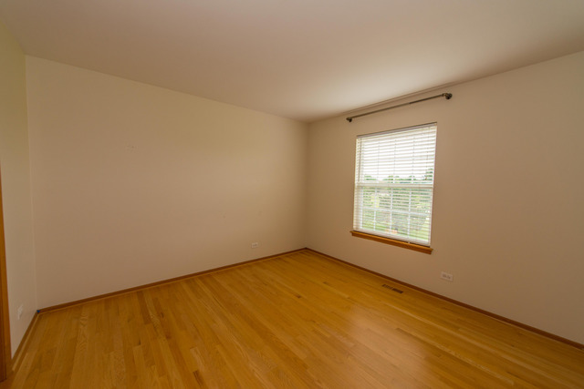 2422 Courtyard Circle, Unit 3 Aurora, IL 60506 - Photo 16 of 25 an empty room with a window