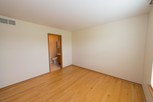 2422 Courtyard Circle, Unit 3 Aurora, IL 60506 - Photo 17 of 25 a view of an empty room and wooden floor