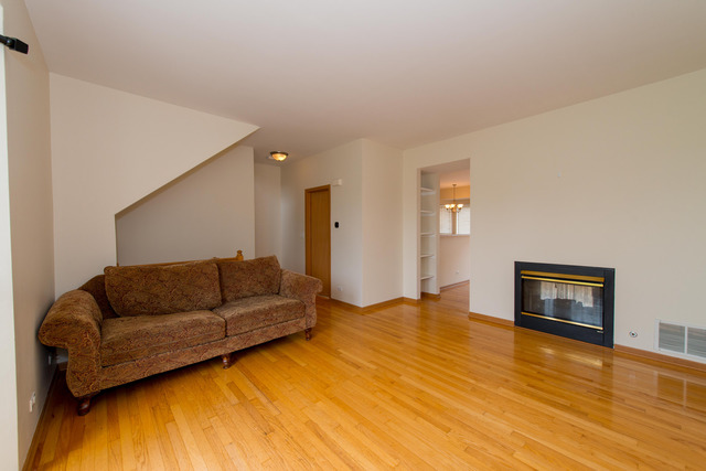 2422 Courtyard Circle, Unit 3 Aurora, IL 60506 - Photo 2 of 25 a living room with furniture and a flat screen tv
