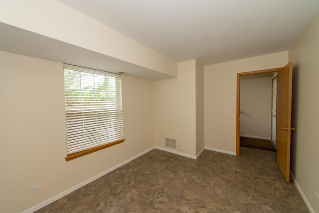 2422 Courtyard Circle, Unit 3 Aurora, IL 60506 - Photo 22 of 25 a view of an empty room with a window