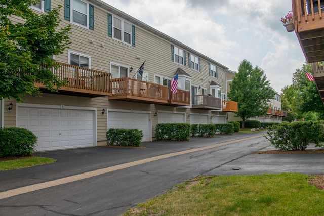 2422 Courtyard Circle, Unit 3 Aurora, IL 60506 - Photo 25 of 25 a front view of a building with garden
