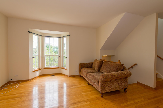 2422 Courtyard Circle, Unit 3 Aurora, IL 60506 - Photo 3 of 25 a living room with furniture and a window