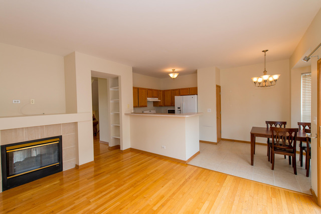 2422 Courtyard Circle, Unit 3 Aurora, IL 60506 - Photo 8 of 25 a view of a kitchen with furniture and wooden floor