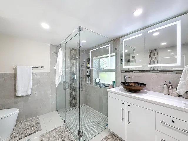 a kitchen with stainless steel appliances granite countertop a sink and a stove