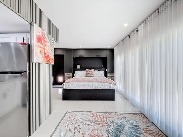 a view of a livingroom with wooden floor and flat screen tv