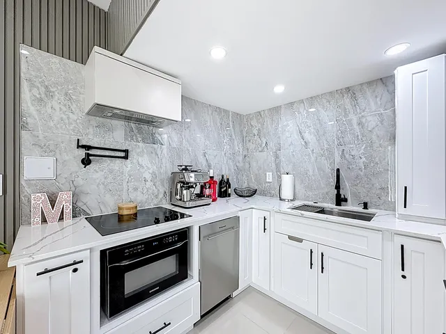 a view of a livingroom with wooden floor and flat screen tv