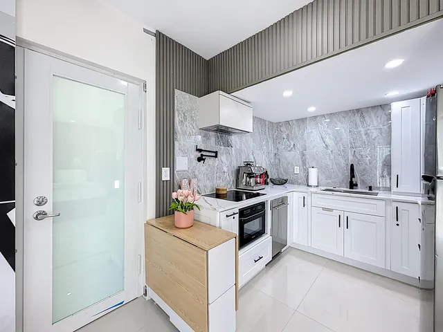 a view of a livingroom with wooden floor and a flat screen tv
