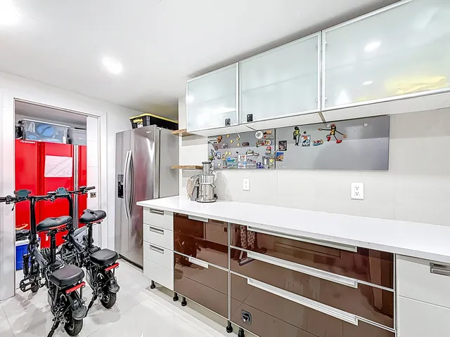 a kitchen with stainless steel appliances kitchen island granite countertop a stove a sink and a microwave