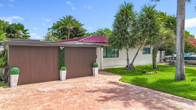 an aerial view of residential houses with outdoor space and trees