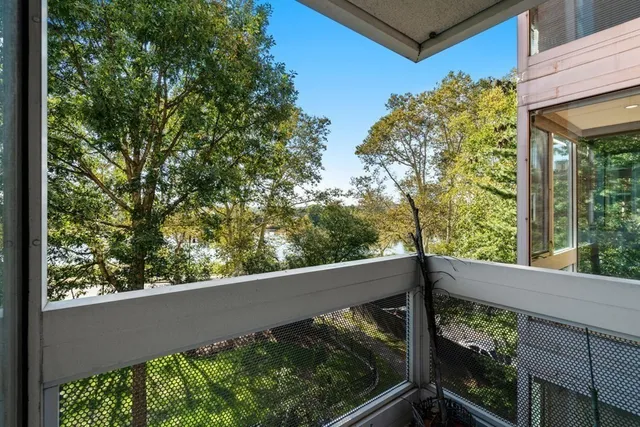 a view of balcony with floor to ceiling window and wooden fence