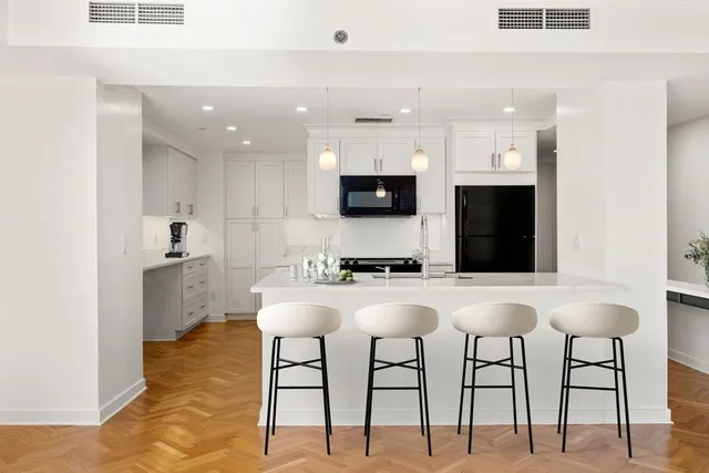 a kitchen with stainless steel appliances kitchen island granite countertop a sink and a stove