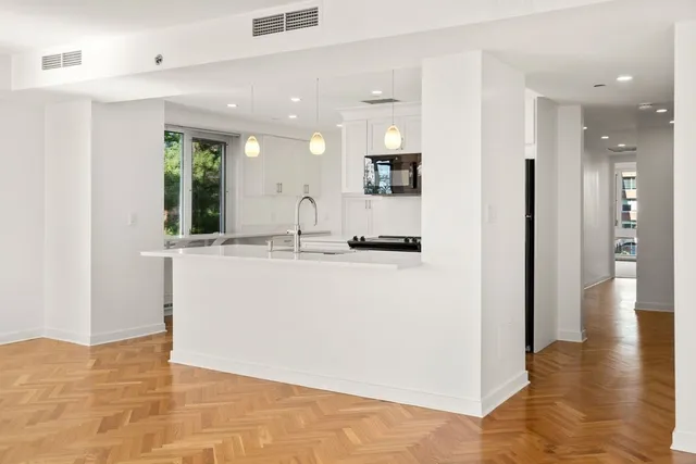 a view of a kitchen cabinets and chandelier