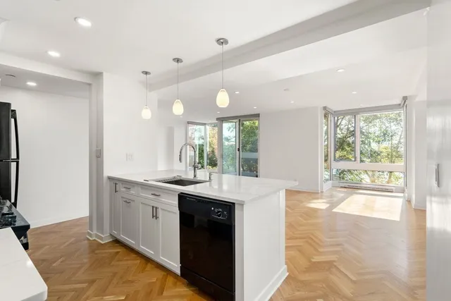 a kitchen with granite countertop a sink and cabinets
