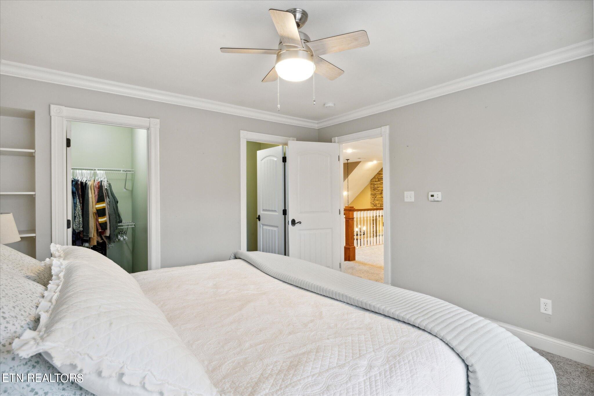 9245 Arlington Ridge Way Powell, TN 37849 - Photo 14 of 36 a bedroom with a large bed and a chandelier