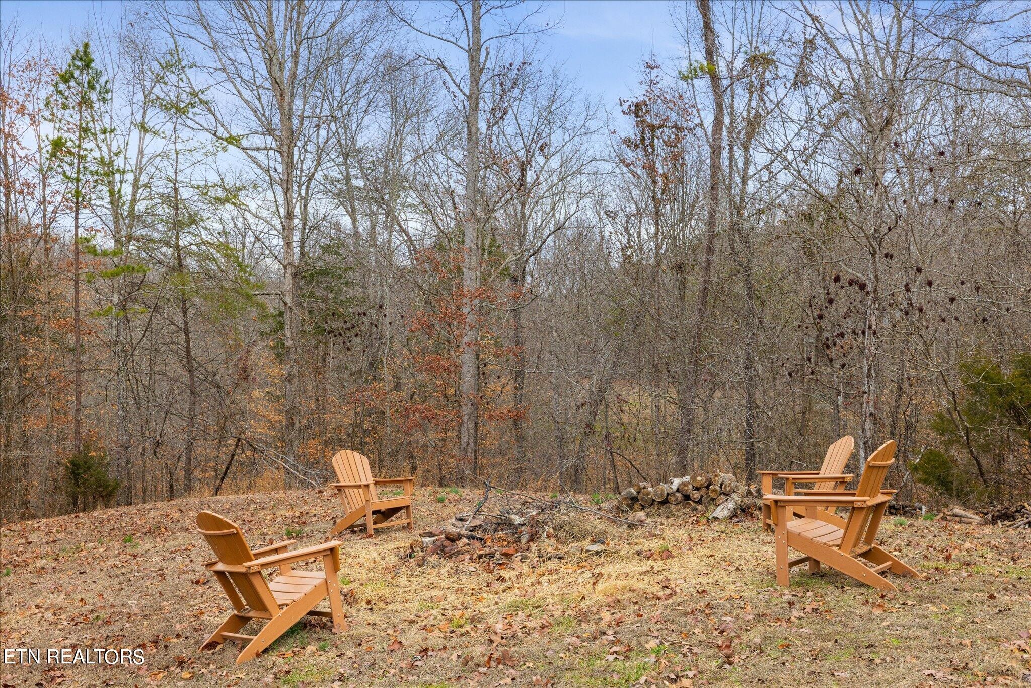 9245 Arlington Ridge Way Powell, TN 37849 - Photo 2 of 36 a backyard of a house with table and chairs