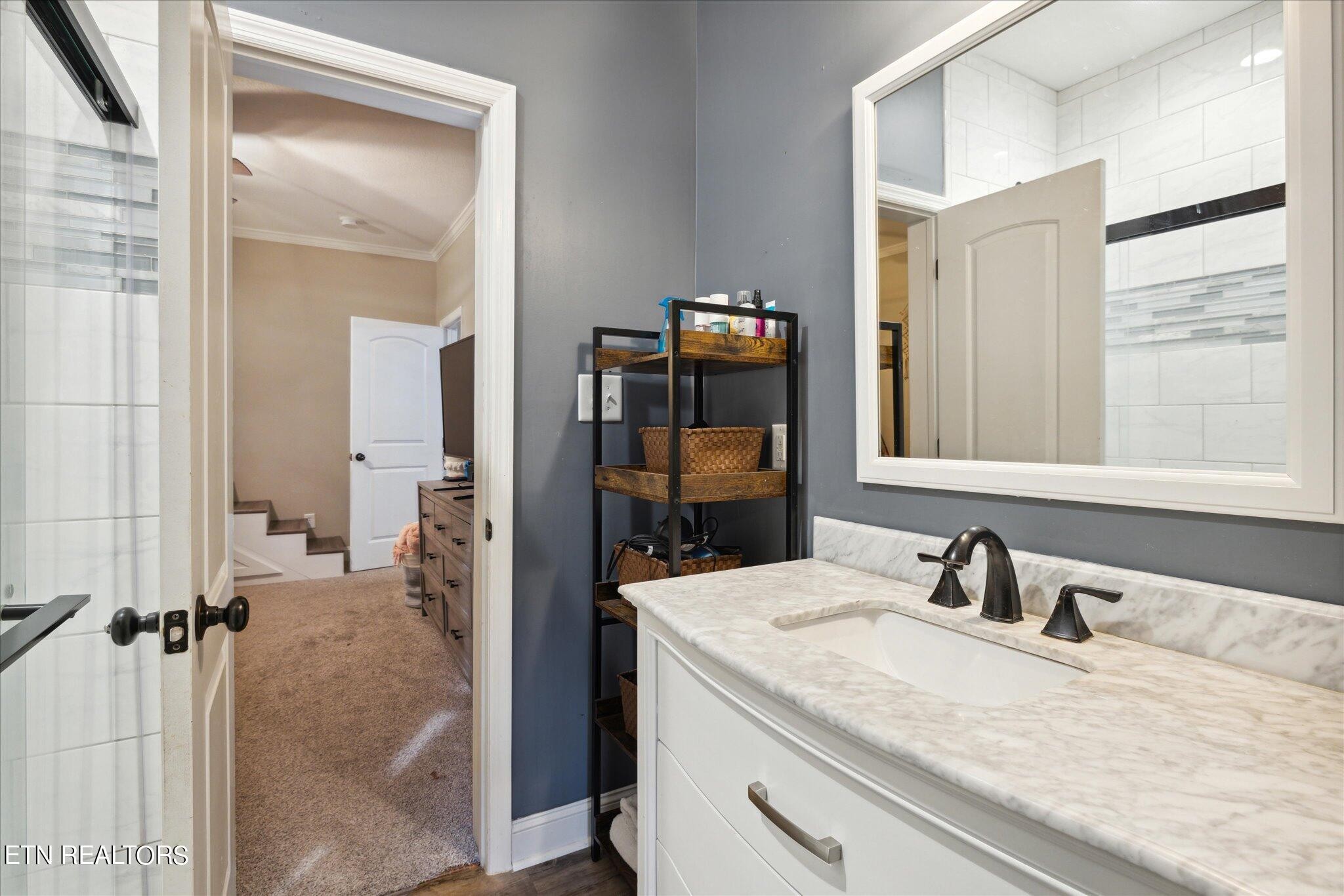 9245 Arlington Ridge Way Powell, TN 37849 - Photo 21 of 36 a en suite bathroom with a sink and mirror