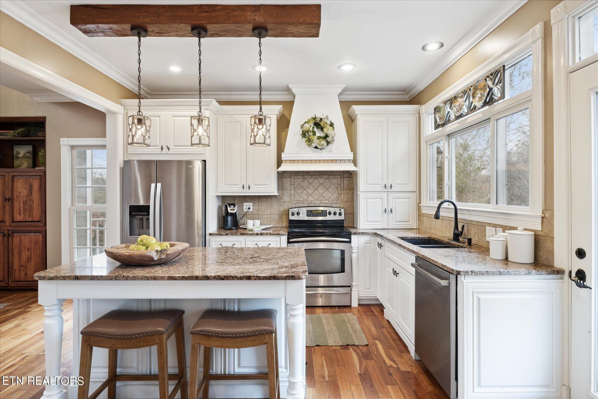 9245 Arlington Ridge Way Powell, TN 37849 - Photo 6 of 36 a kitchen with granite countertop a sink appliances cabinets and furniture