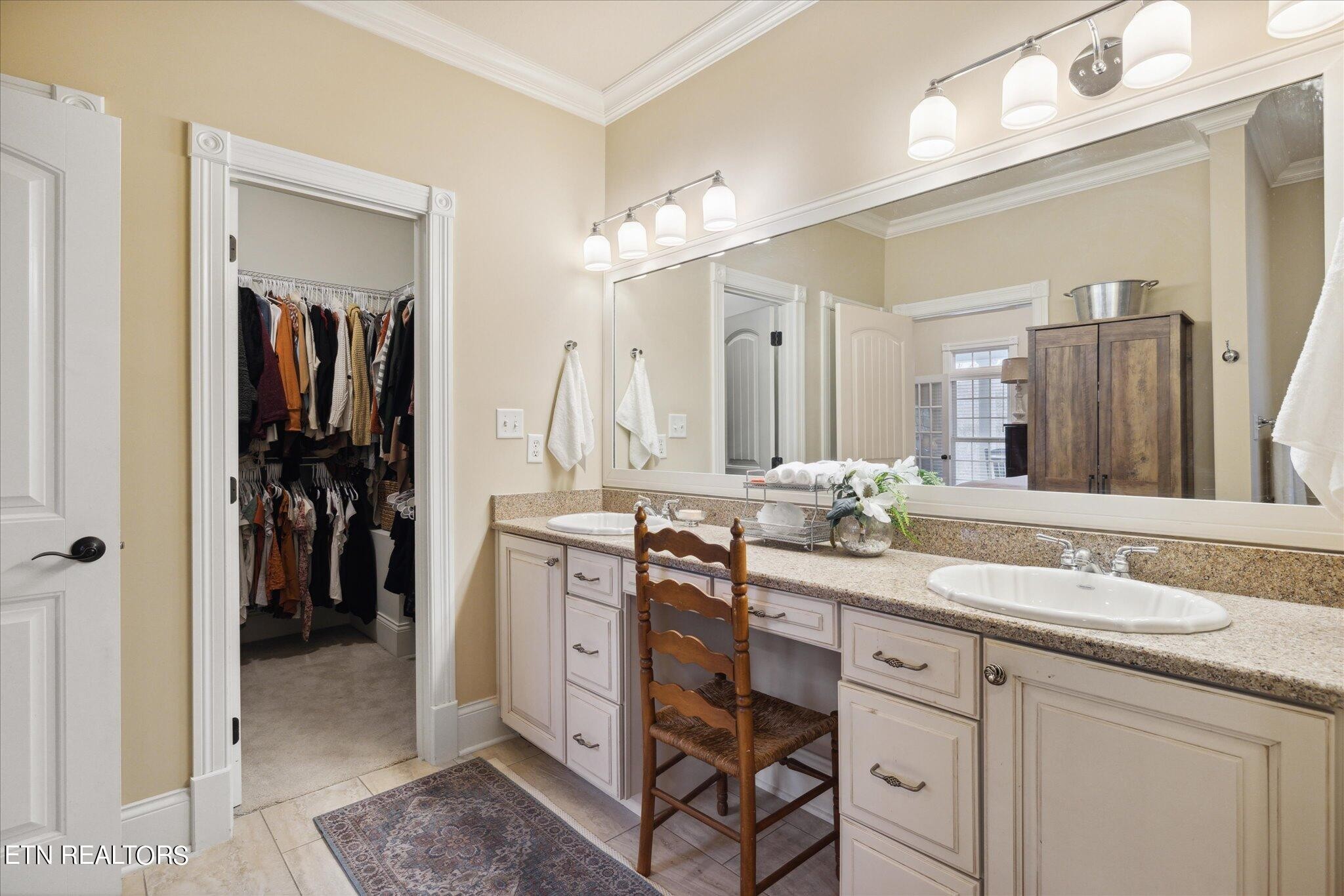 9245 Arlington Ridge Way Powell, TN 37849 - Photo 10 of 36 a bathroom with a double vanity sink and a mirror