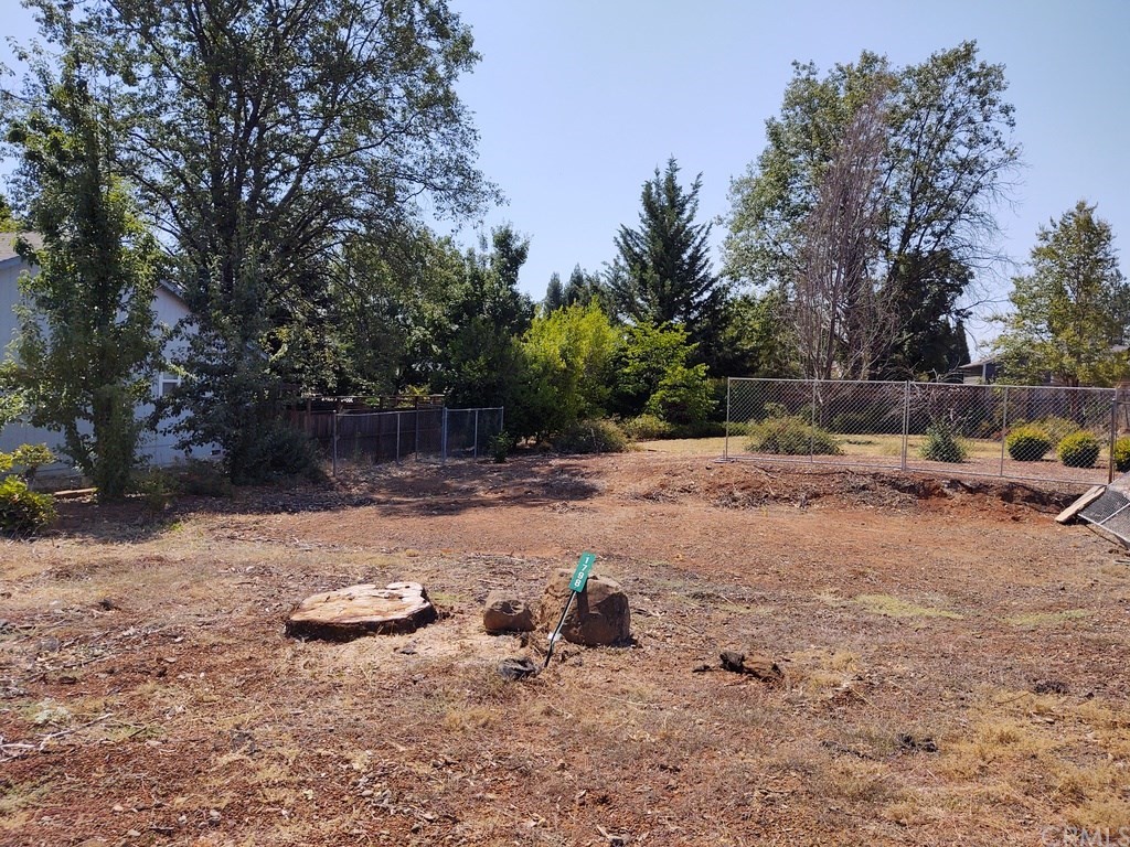 1798 Merrill Road Paradise, CA 95969 - Photo 1 of 1 Picture of lot as it is in August 2020. Tree was removed. Neighbors on left and back. Yard still has some landscaping.